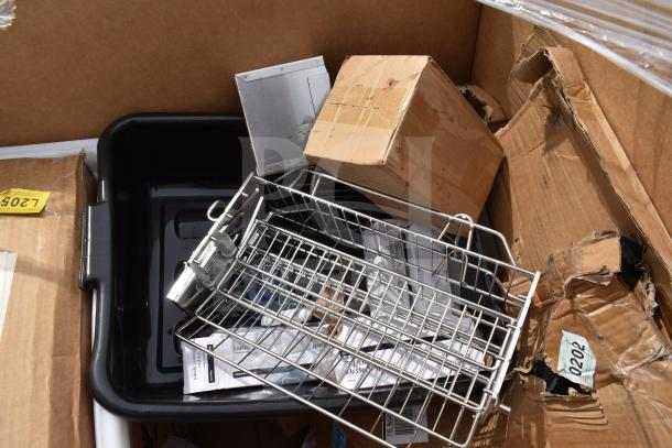 Box containing a black plastic bin, metal rack, and damaged cardboard, labeled L2057. New scratch and dent items.