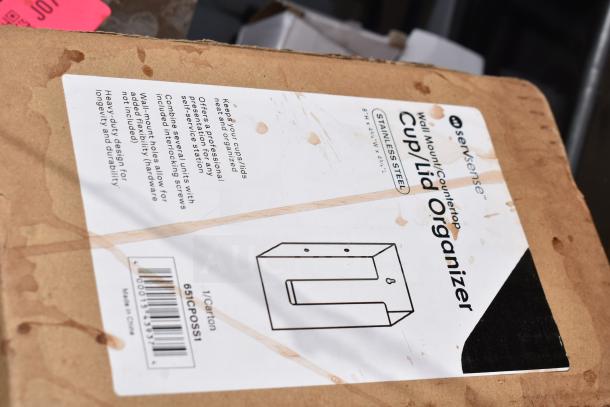 Cardboard box labeled "ServSense Cup/Lid Organizer," stainless steel, wall mount/countertop use, 8"x4.5"x8" dimensions.