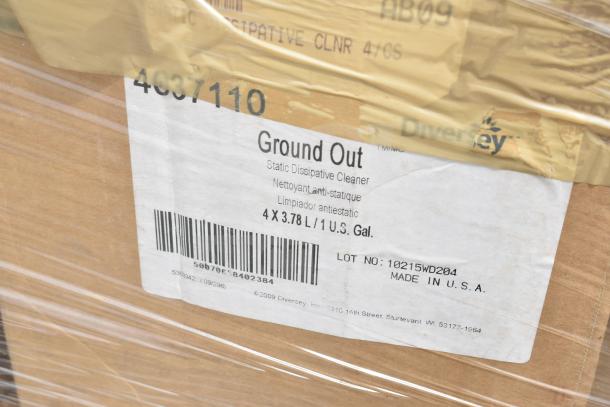 Cardboard box labeled with "Ground Out Static Dissipative Cleaner, 4 x 3.78L/1 U.S. Gal." by Diversey, Lot No. 10215WD204, Made in USA.