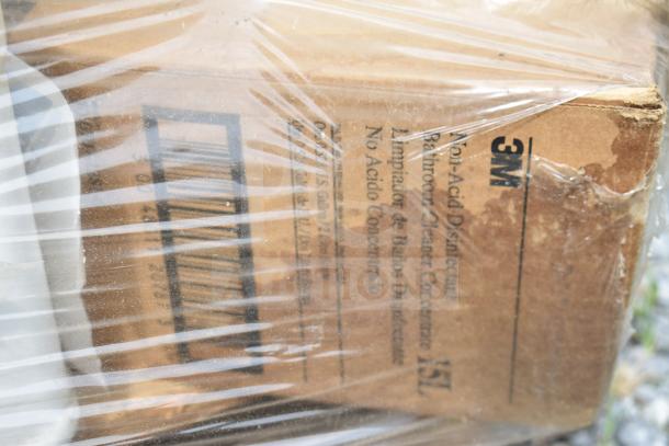 Cardboard box of 3M non-acid disinfectant bathroom cleaner concentrate, wrapped in plastic, visible text and barcodes.