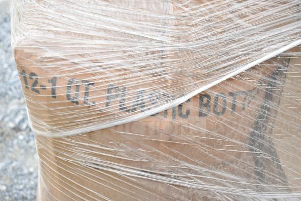 Plastic-wrapped pallet containing boxes labeled "12-1 QT. PLASTIC BOTTLES," suggesting various new scratch and dent cleaners.