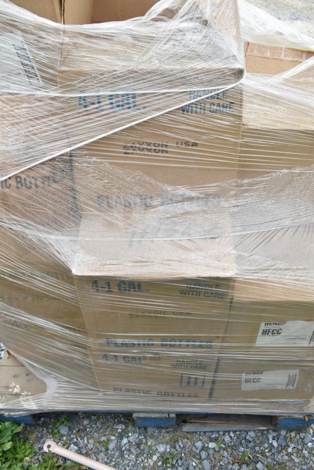 Boxes of scratch and dent items including various cleaners, sealed in plastic wrap on a pallet. Labels read "4-1 Gal," "Handle With Care."