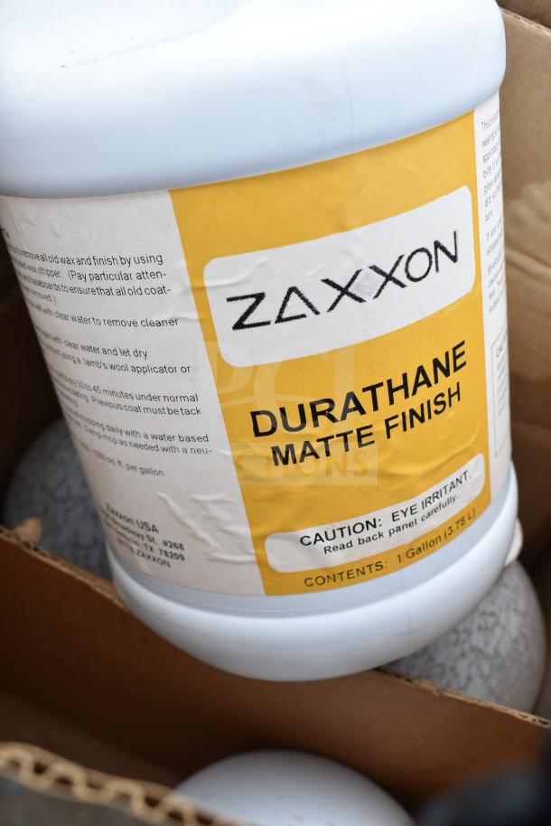 Zaxxon Durathane Matte Finish, 1-gallon bottle, brand new with slight visible dents. Caution label indicates eye irritant.