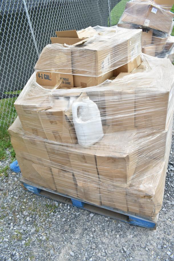 Pallet of 38 new scratch and dent cleaners and bottles, shrink-wrapped, includes 4-gallon boxes, outdoor setting.