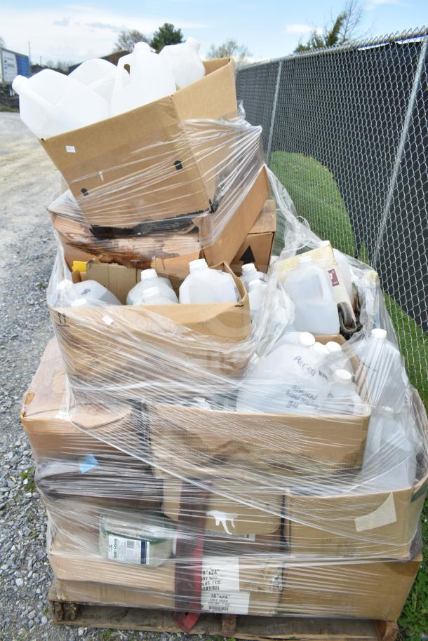 25 new scratch and dent items, including various cleaners and vinegar bottles, wrapped on a pallet.