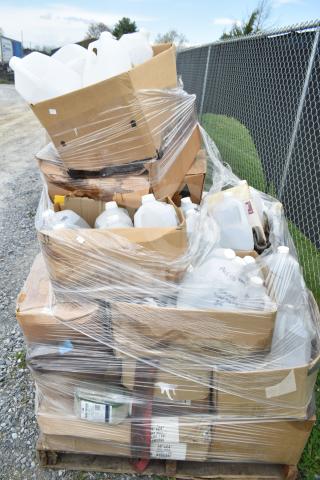 25 new scratch and dent items, including various cleaners and vinegar bottles, wrapped on a pallet.