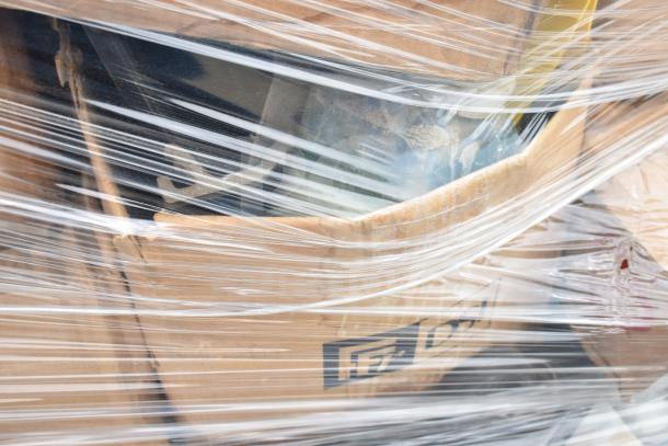 Pallet of 25 new scratch and dent items, including cleaners and vinegar bottles, wrapped in plastic for auction.