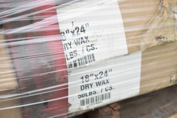 Shrink-wrapped cardboard boxes labeled "18x24 Dry Wax 50 lbs/cs," with barcode visible.