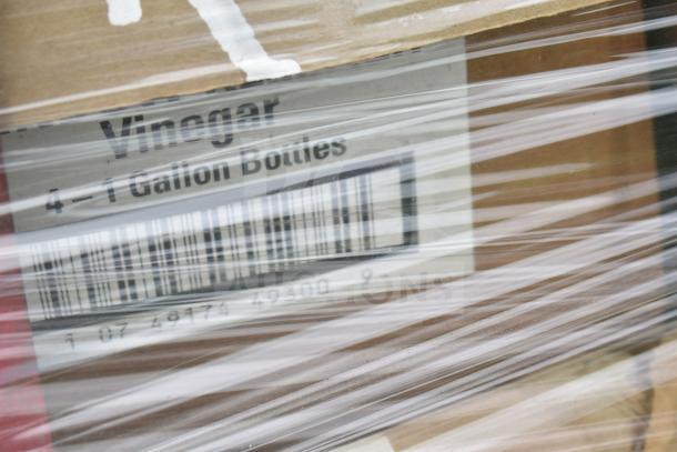 Packaged items labeled 4x1 gallon vinegar bottles, brand new, with some scratch and dent. Wrapped in clear plastic.