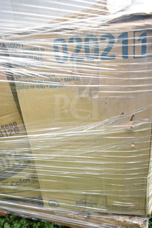 Plastic-wrapped pallet containing boxes labeled with "Scott Roll Towels" and number "020211", indicating mixed cleaning supplies.