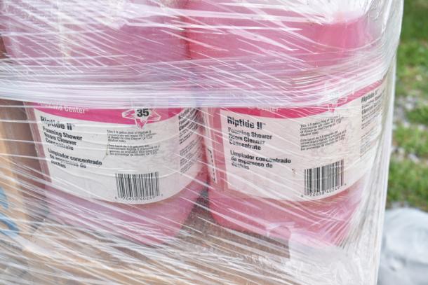 35 new Riptide II Foaming Shower Cleaner containers wrapped in plastic, showing label details and batch number.