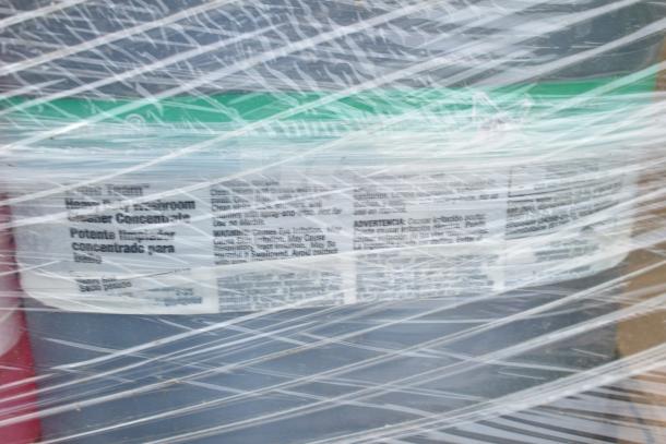 Packaged assortment of 35 scratch and dent cleaning products. Labels show "Heavy Duty Restroom Cleaner Concentrate."