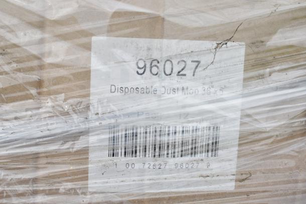 Plastic-wrapped pallet showing a blemished box labeled "96027 Disposable Dust Mop 36 inch," indicating product type.