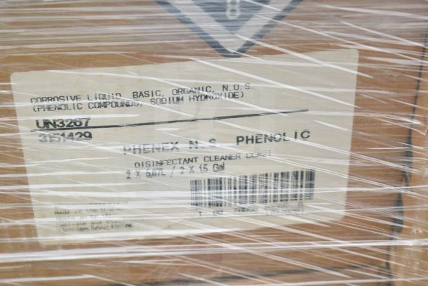 Plastic-wrapped box labeled "Rhenex N.S. Phenolic Disinfectant Cleaner," features corrosive liquid warning, UN3267 code.