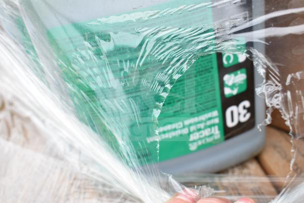 Image of a plastic-wrapped container labeled "30," part of a lot of 35 brand new scratch and dent cleaning items.