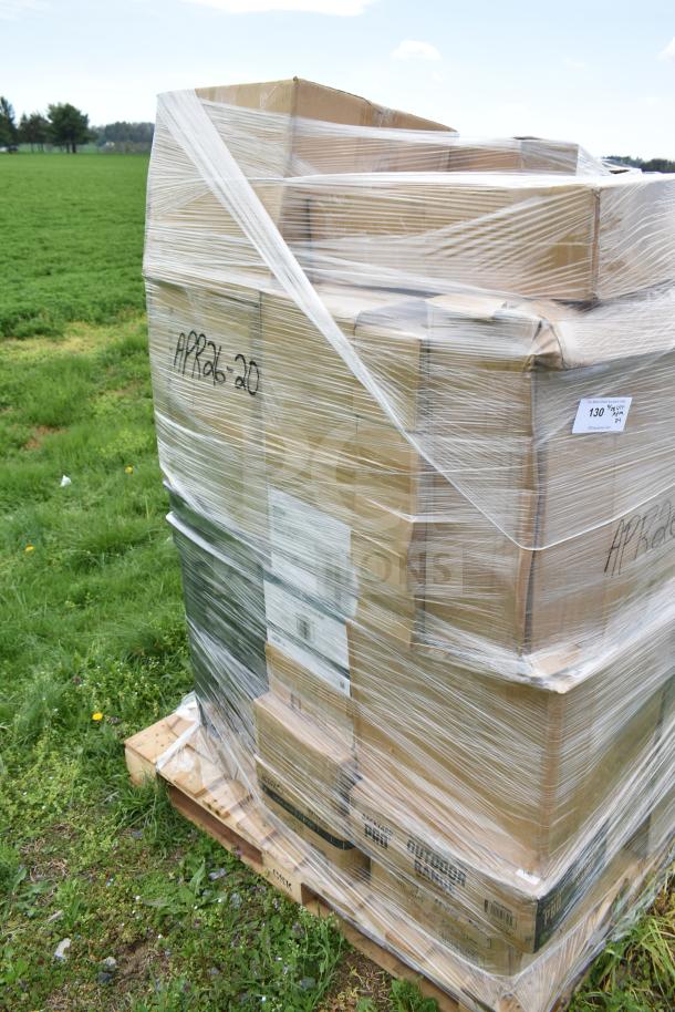 Pallet of new scratch and dent items, including plates and cutting boards, wrapped in plastic with "APR26-20" marking.
