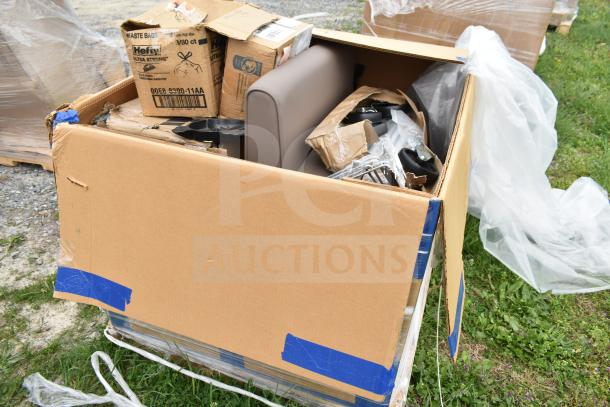 Box containing new scratch and dent items, including parts of a sofa and various kitchen pans. Boxes labeled "Hefty."