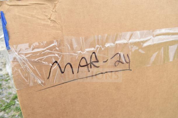 Cardboard box marked "MAR-24" containing a lot of 10 brand new scratch and dent items, including a sofa and pans.