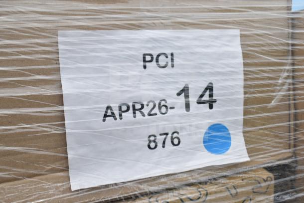 Pallet wrapped in plastic with label reading "PCI APR26-14 876," containing 23 new items like dessert and hot cups.