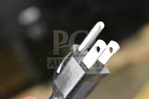 Three-prong plug of the Estella 236ECEG26 countertop espresso grinder, 110/120 volts, new with minor scratches.