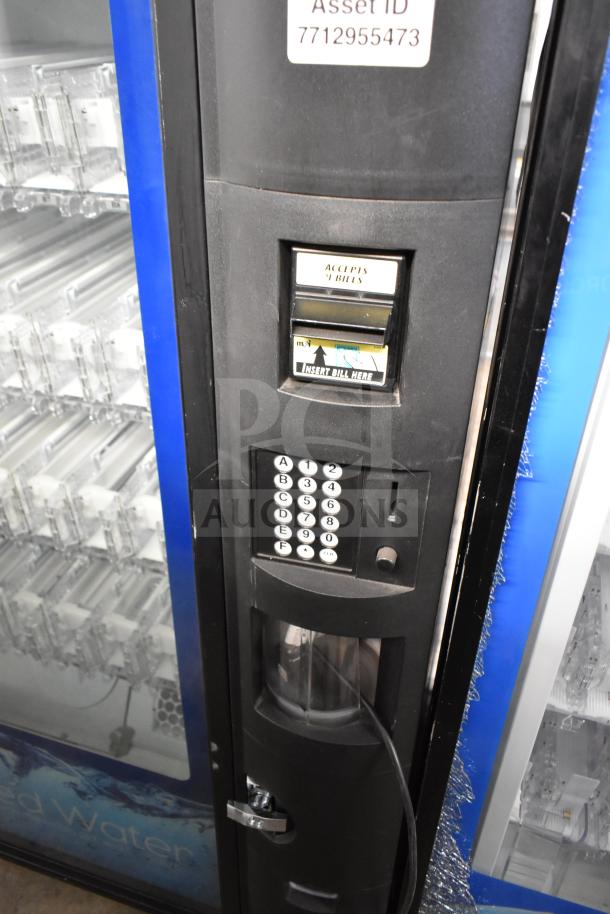 Crane 5800-4 commercial bottled drink vending machine with bill acceptor. Features keypad, asset ID 7712955473, used condition.
