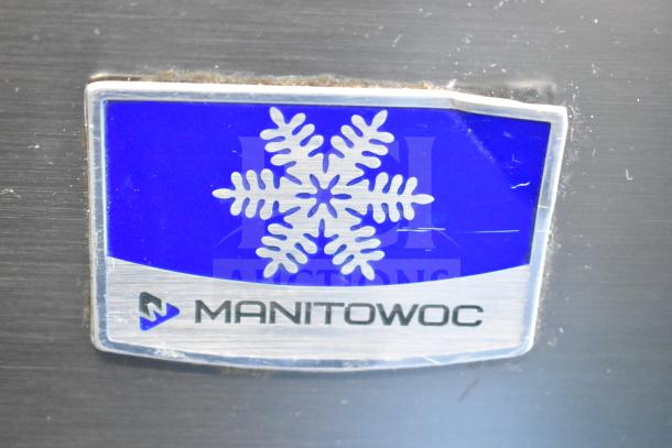 Manitowoc UYF0140A-161B ice machine logo. Model label visible, blue snowflake design.