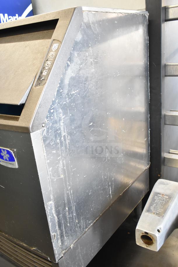 Manitowoc UYF0140A-161B ice machine, metallic finish, visible wear. Model tag shows 115V, 1 Phase. Suitable for commercial use.