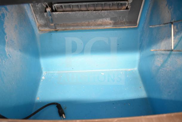 Manitowoc UYF0140A-161B ice machine interior, blue compartment, used condition, includes power cord.