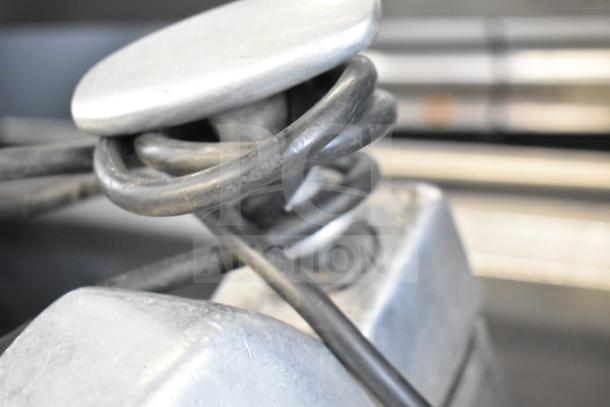 Close-up of Hobart 84145 Buffalo Chopper's metal components, showcasing sturdy build and industrial quality.