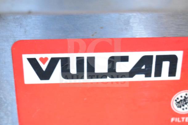Vulcan logo on commercial floor-style 2-bay deep fat fryer with fry baskets, mounted on commercial casters.