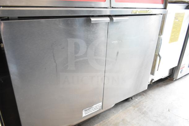 Vulcan commercial 2 bay deep fat fryer on casters, includes fry baskets, label notes gas shutoff location, stainless finish.