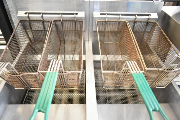 Vulcan 2-bay commercial deep fat fryer with fry baskets on casters. Durable and efficient for high-volume frying.