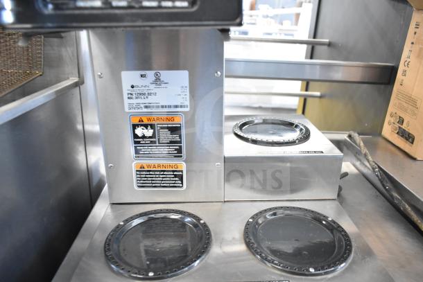 2024 Bunn CWTF15 commercial coffee machine with 3 burners, stainless steel, labels for model and safety warnings visible.