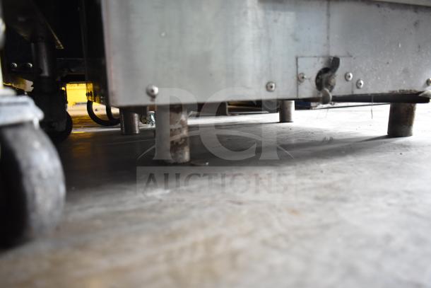 Commercial electric steam and hold cabinet legs, showing metal construction and ground-level placement. Suitable for 208/240 volts.