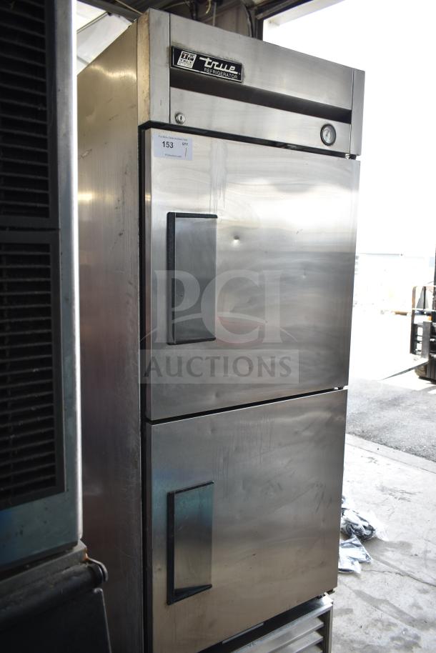 True T-23-2 commercial reach-in cooler, 2 half-size doors, stainless steel, on casters, 115V, 1 phase. Light wear visible.