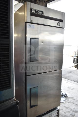 True T-23-2 commercial reach-in cooler, 2 half-size doors, stainless steel, on casters, 115V, 1 phase. Light wear visible.
