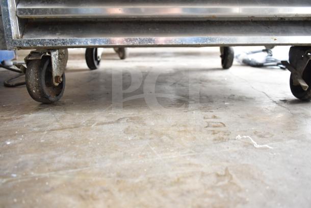 True T-23-2 Commercial 2 Half Size Reach In Cooler on casters, 115 volts, 1 phase, shown from a low angle.