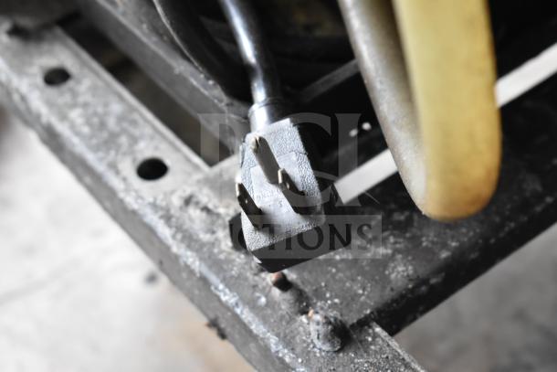 Power plug of True T-23-2 Commercial Reach-In Cooler, showing standard 115-volt connection, minor wear visible.