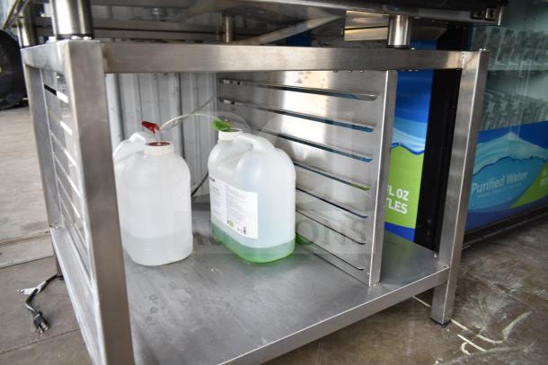 Stainless steel base of Vulcan V1PJ102G-81 combi oven with storage space and two chemical containers underneath.