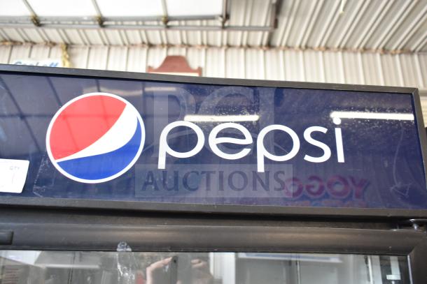 QBD DC26HB single door reach-in cooler with Pepsi branding. Used condition, commercial-grade, 115 volts, 1 phase.