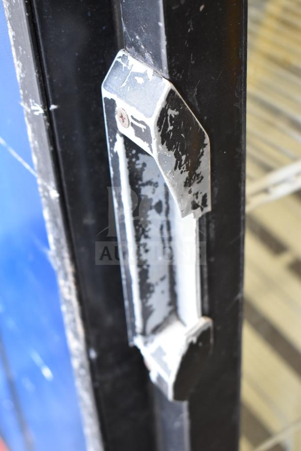 QBD DC26HB cooler door handle, showing signs of wear. Black finish with visible paint chipping.