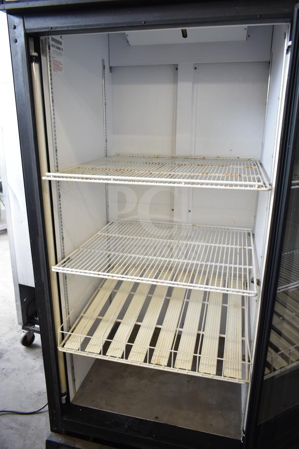 QBD DC26HB Commercial Single Door Reach In Cooler, 115V, 1 Phase, with adjustable wire shelves, shows signs of use.