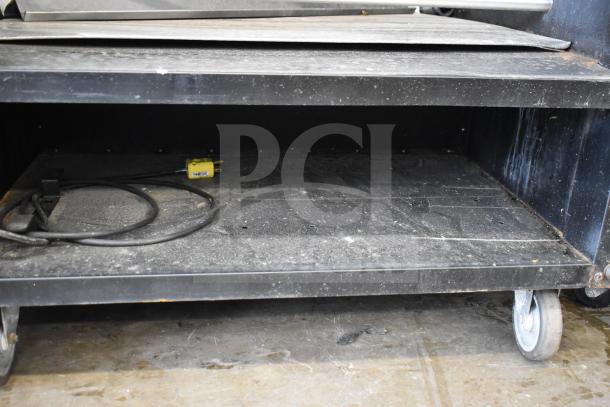 Vulcan 1013776 Pastry Merchandiser, floor style, on commercial casters, used condition, visible power cord and plug.