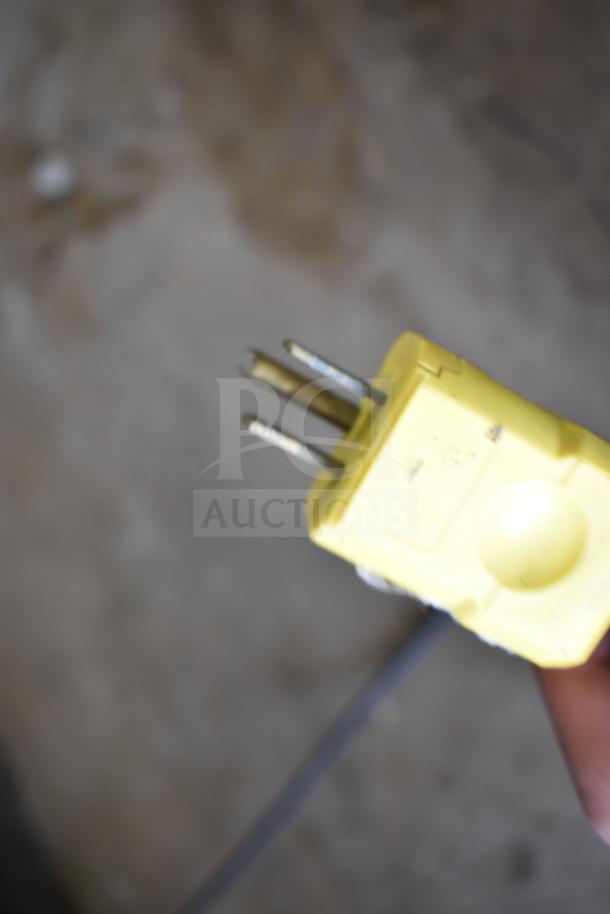 A close-up of a yellow electrical plug with visible prongs and slight wear, suitable for a Vulcan 1013776 merchandiser.