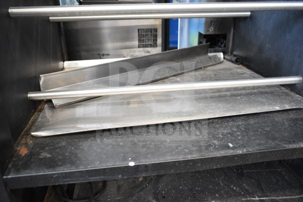 Vulcan 1013776 commercial pastry bakery bagel merchandiser on casters; metal shelves, visible wear, industrial-grade design.