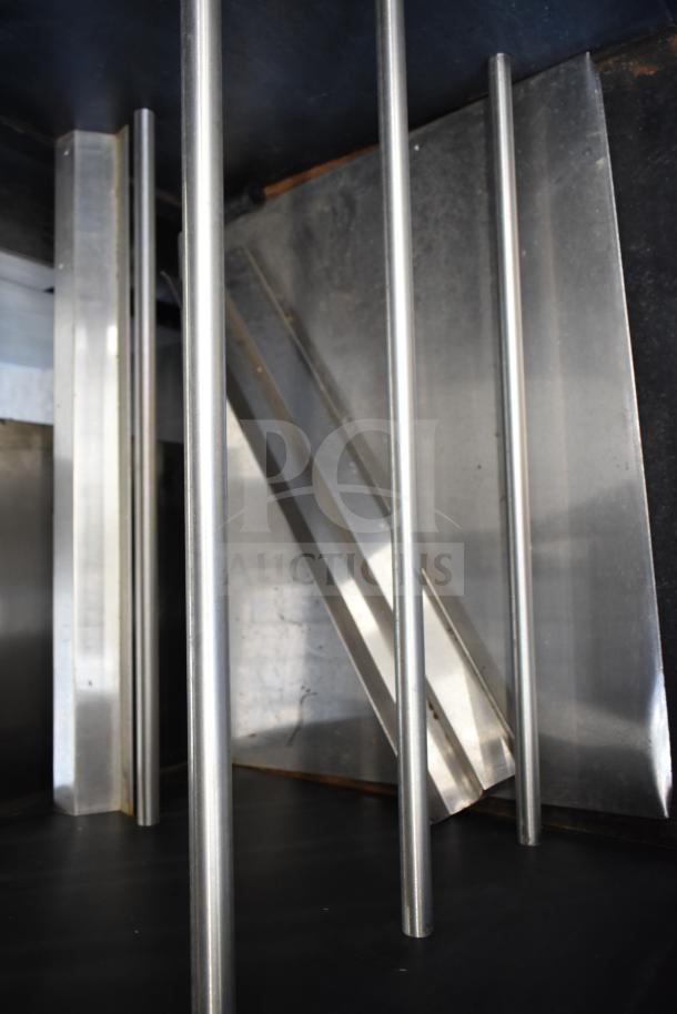 Vulcan 1013776 pastry merchandiser interior view, stainless steel rods, commercial floor style, mounted on casters.