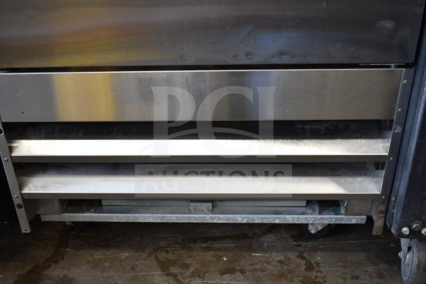 Coldline C-1FE commercial freezer, single door, with pan rack on casters. Features 115V, 1 Phase. Durable stainless steel finish.