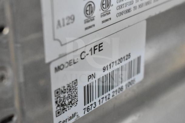 Label showing Coldline C-1FE model number, barcode, and certification marks on a commercial freezer.