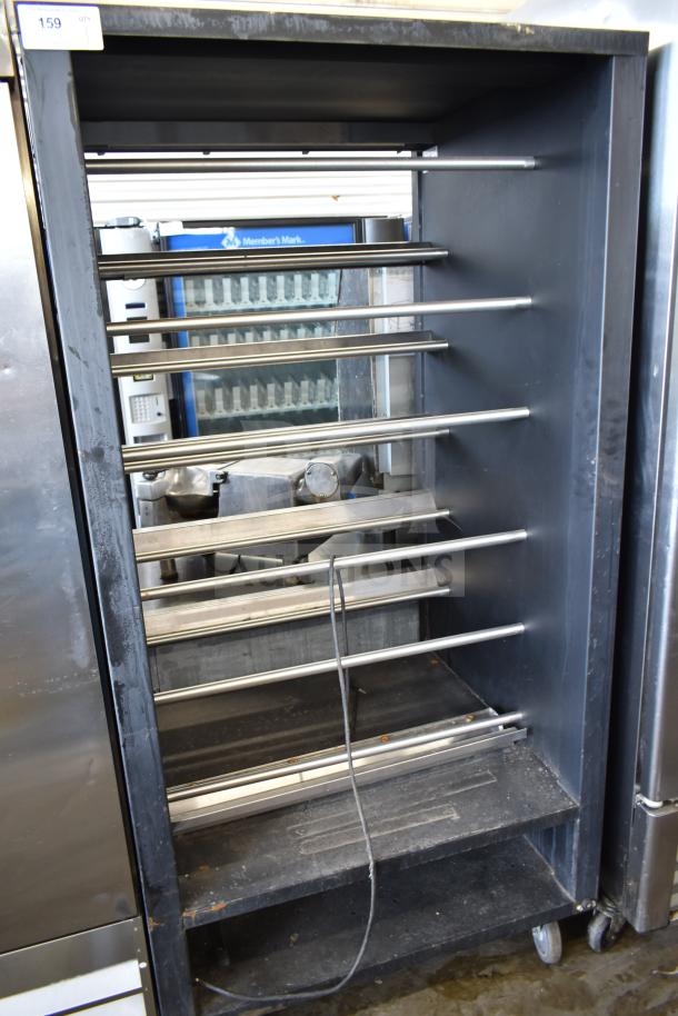 Vulcan 1013776 commercial pastry merchandiser on casters, steel racks, used, industrial design, visible wear.