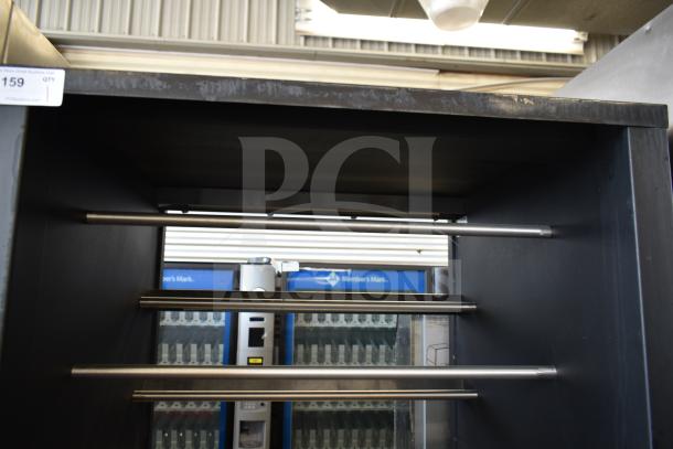 Vulcan 1013776 commercial pastry merchandiser, metal frame, empty shelves, commercial casters, visible usage marks.